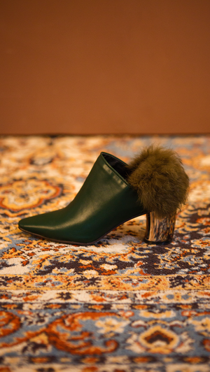 The Ravello Fur Mules in Green. Slide loafers with a pointy toe, padded leather foot bed and rubber soles. Slip on.  