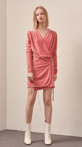 The Reve Velvet Dress in Pink. Featuring dee[ V-neckline, ruched shoulder sleeves, wrap front with self-tie at waist. Stretchy fabric.