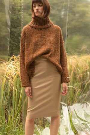 Pullover sweater with chimney collar with dropped shoulders. Gently tapered long sleeves. Slightly cropped. Boxy silhouette. Softy, bulky garter stitch knit. Relaxed fit.