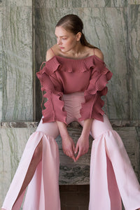 The Cheysa Pant in Pink featuring peplum leg trouser, gently flare out hem with side slits. Slim-fitting at thigh. High rise. Centre-front concealed zip fly and hook closure.