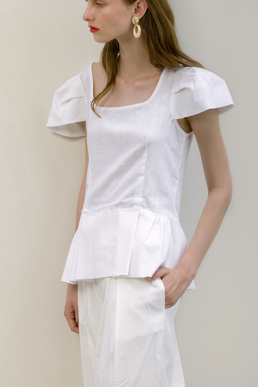 The Rosario Top in White featuring square neckline, cap short sleeves. Pull on. Relaxed fit.  