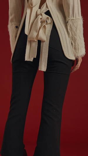 Rosendale Knit in Ivory. With a faux shearling cuffs in contrasted colour and button closing detail, backless with extra long self-tie closure. Open rib details. Designed to be slightly relaxed fit.