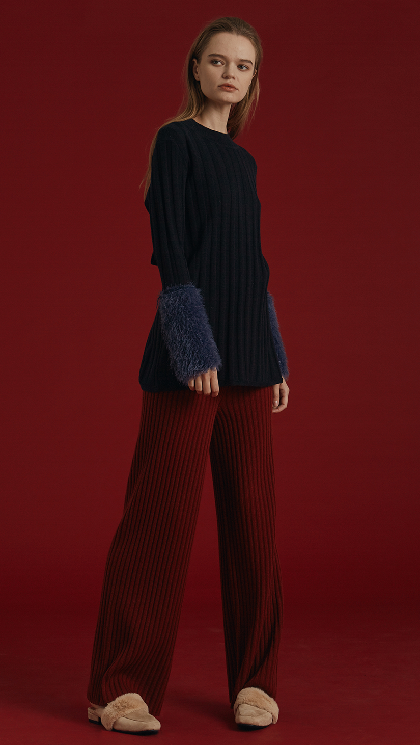 The Mikaela Pant is brick wool trousers sit high on the waist with an elasticated ribbed-knit trim. Wide leg cut. Extra long in length. No pockets. Warm and super soft wool fabric. Relaxed fit. Wholegarment Made.