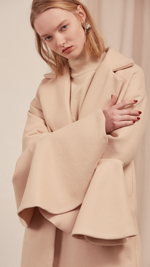 The Ruliette coat styled with gathered wide flare sleeves. With raw-edge ruffled puff sleeves, oversized felt-faced point collar, convertible notch lapel, back drop shoulders, one button closure at front, on-seam vertical slip pockets. Fully lined. Mid-weight.