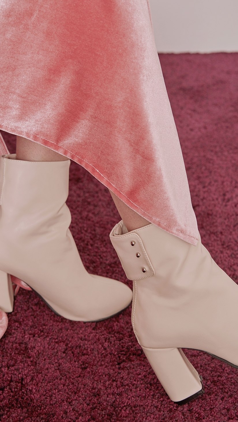 Ayala Midi Boots in Cream Ivory. Soft synthetic leather upper, slouchy design in almond toe and zip opening at back with snap buttons. 