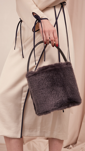 Seed Furry Bucket bag in Lava Grey. Main compartment with adjustable strap, detachable shoulder strap, interior pocket with zipper compartment. Structured bottom.