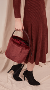 Seed Furry Bucket bag in Wine. Main compartment with adjustable strap, detachable shoulder strap, interior pocket with zipper compartment. Structured bottom.