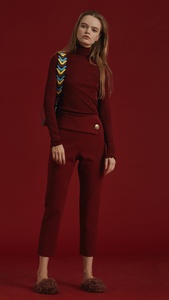 The Siena Pant is high waisted, cropped carrot trousers with gold hardware detailing in Bordeaux. Concealed zip closure along side. No pockets. 