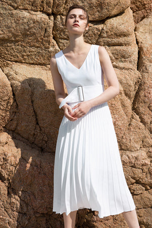 The Simma Dress in White, featuring v-neckline, sleeveless, removable wide belt, pleated skirt. Concealed zip fastening at the back. Fully lined.