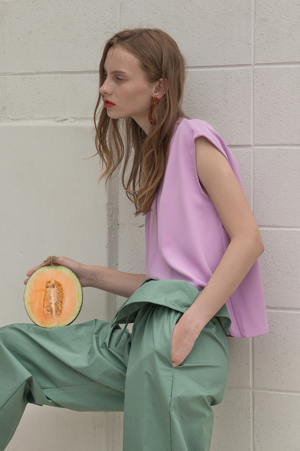 The Sofie Top in Lilac featuring cap short sleeves, asymmetric cropped hem, keyhole closure at back. 