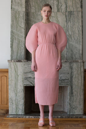 The Soliel Dress in Bubblegum, featuring raglan bubble half sleeves, waistline with drawstring for cinching, concealed zip fastening at the back. Fitted at waist. Back slits.