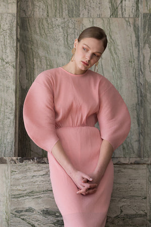 The Soliel Dress in Bubblegum, featuring raglan bubble half sleeves, waistline with drawstring for cinching, concealed zip fastening at the back. Fitted at waist. Back slits.