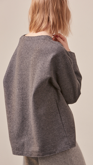 The Stiü wool blend sweater in dark grey with a deep V-neckline, long sleeves. Pull on. Lightweight. Non-stretchy. Relaxed fit. 