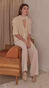Short sleeved pullover with deep v-neck in ivory wool. A matching tassel scarf gathers. Pull on. Designed to be loose fit.