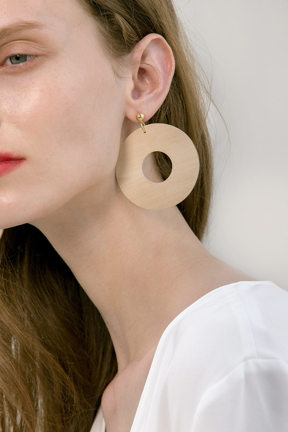 The Taza, a pair of round bamboo earrings. Gold metal post back. Sold as a set.