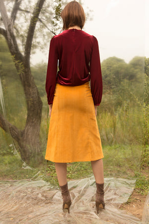 Mid length skirt with center zip fastening detailing. Fitted through hips. A-line silhouette.