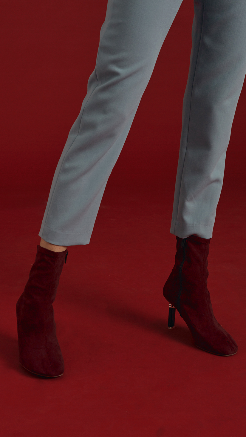 Stretch smooth suede fabric ankle boots in burgundy. Matching a thin stiletto structure in black with almond square toe. Zip fastening along side. Ankle length.