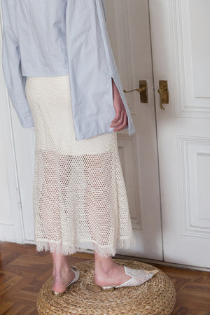 The Veste Skirt in Cream Ivory featuring elasticated waistband with net detailing. Tassel edged. Partial lined. 