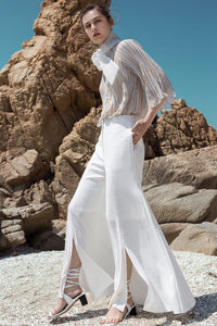 The Yulia Pant in white featuring wide-leg with gathered slits. Mid- rise. Centre-front concealed zip fly and hook closure. Particularly long in length. Partially lined.