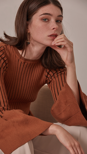 Etre Sweater in Brown. Oversized puffs on exaggerated cuffs, rib knit in the avant-grade silhouette. Voluminous bell sleeves in cropped length top with side slit. Rounded hem. Super soft feel. Designed to skim the body. The slim fit makes it a natural for laye