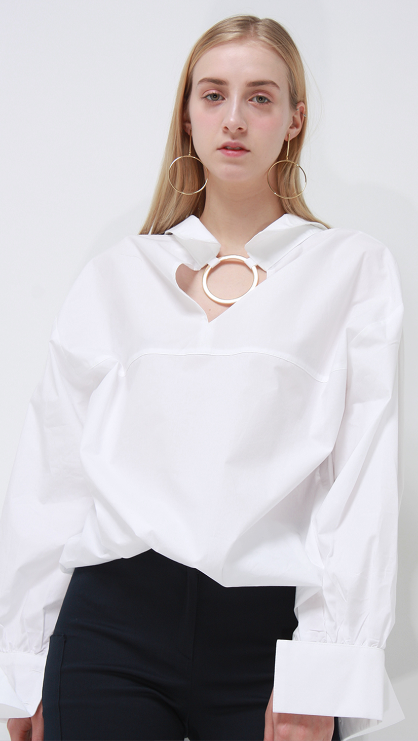Lemaire crisp white classic shirt with gold circular ring. 