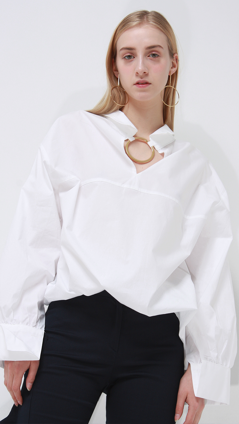 Lemaire crisp white classic shirt with gold circular ring. 